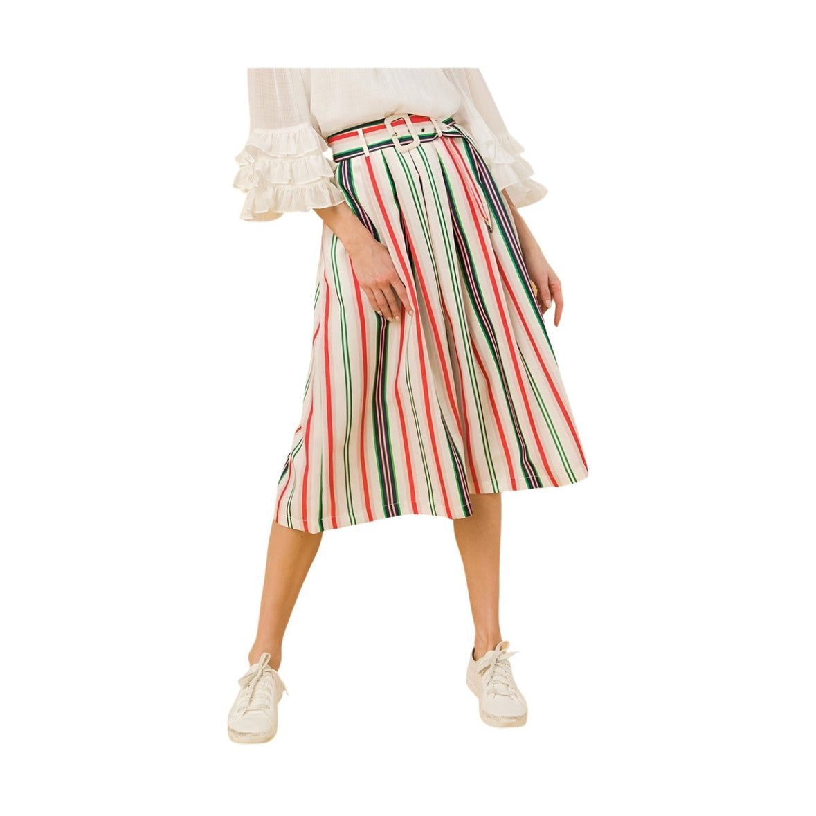 Colorful striped vacation skirt with belt worn by woman paired with white shoes and ruffled blouse