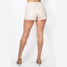 VacationGrabs faux leather cargo shorts women in beige shown from the back with pockets and high heels