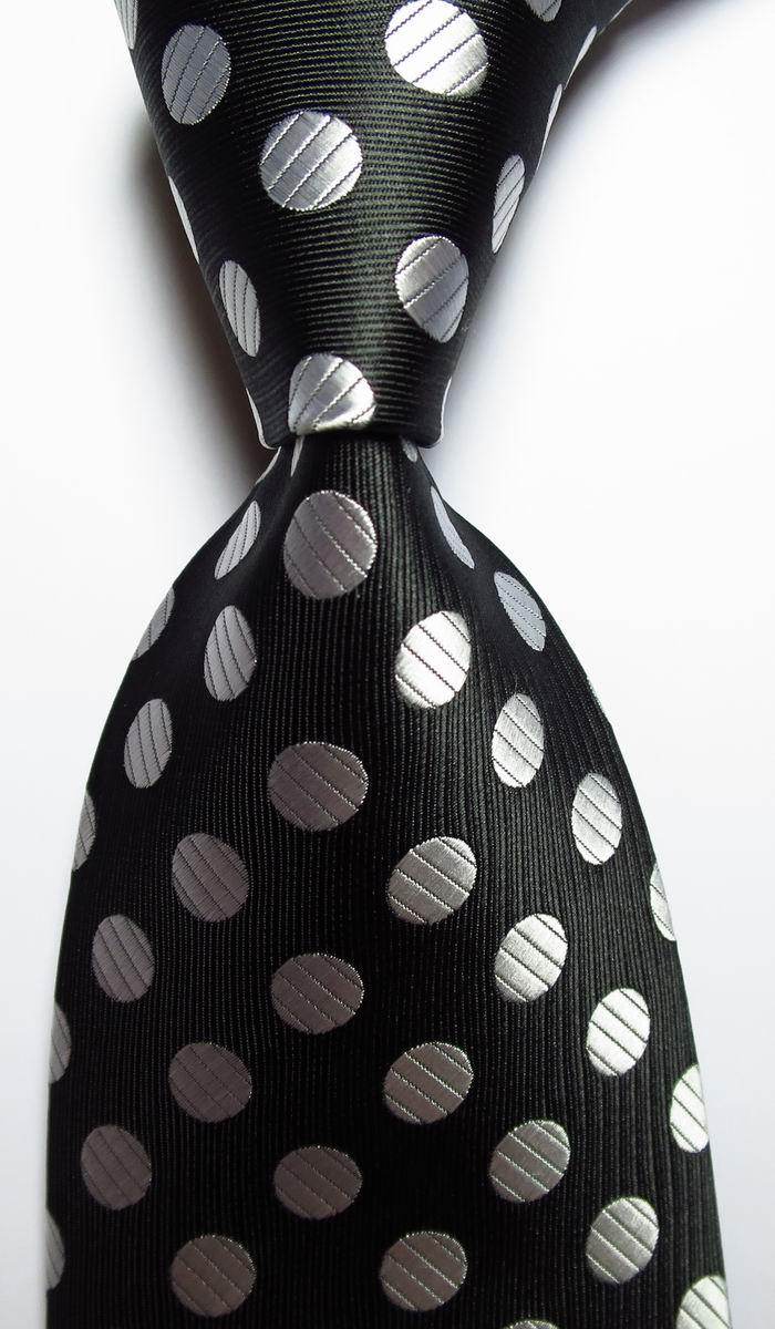 Elegant gold green necktie set with shiny silver polka dots on a black background