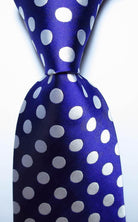 Elegant gold green necktie set featuring a vibrant polka dot design on a deep blue background