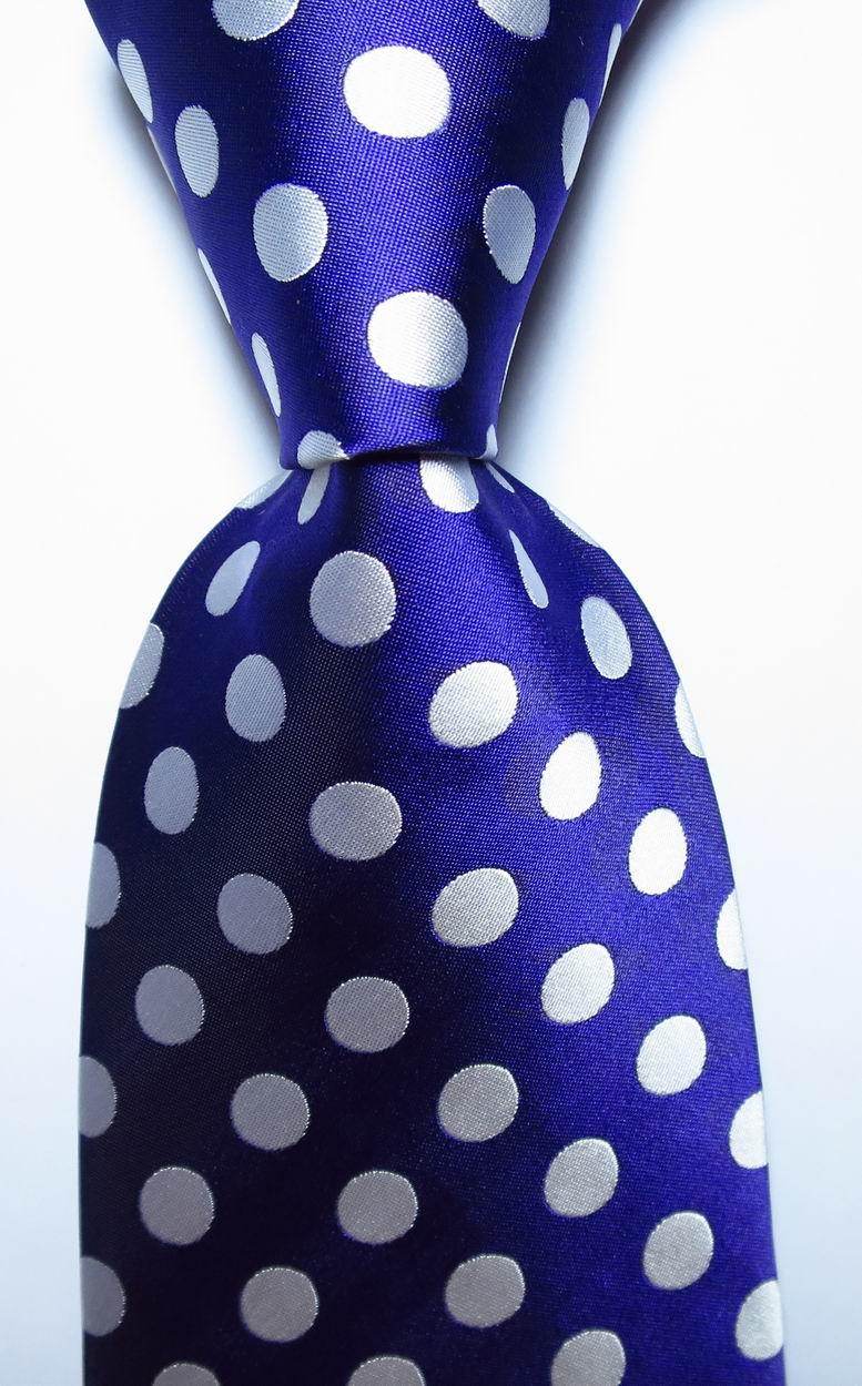 Elegant gold green necktie set featuring a vibrant polka dot design on a deep blue background