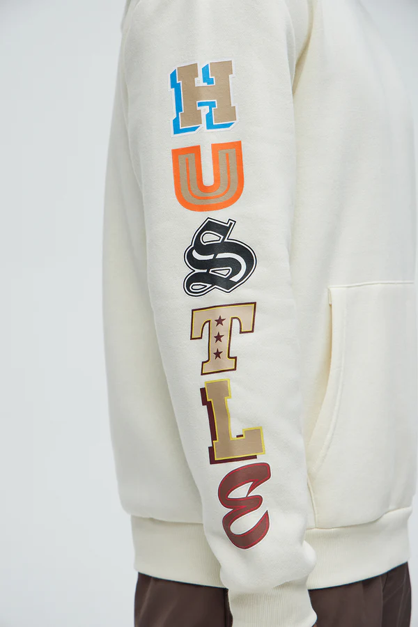 Cream hustle daily hoodie for vacation with colorful bold lettering on sleeve by VacationGrabs