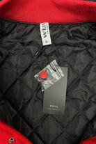 Inside view of WEIV red letterman jacket for men with quilted lining and brand tag