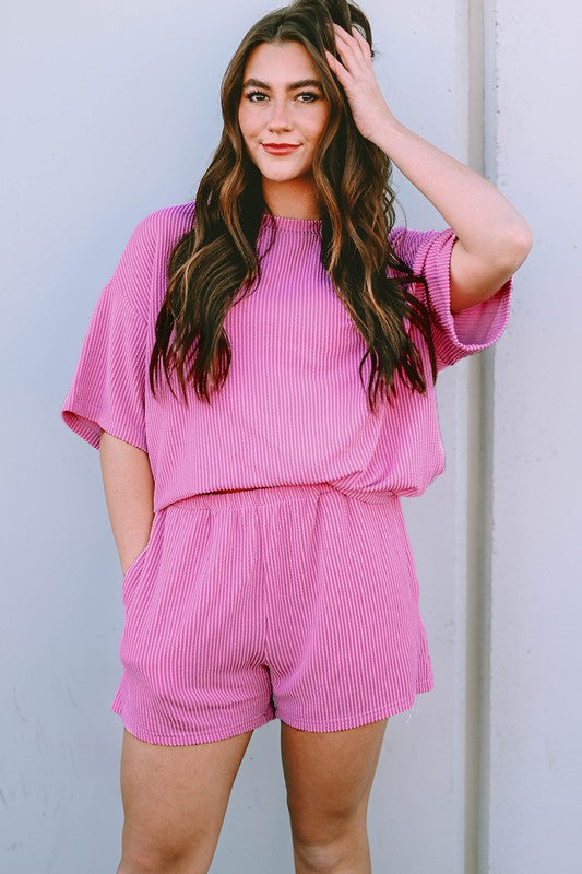 Pink ribbed textured matching set for women featuring a loose top and elastic waist shorts