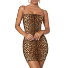 Woman wearing a sexy tiger stripe mini dress with thin straps and fitted silhouette
