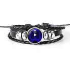 Unique zodiac sign wristbands with a braided black leather design and a blue gemstone centerpiece