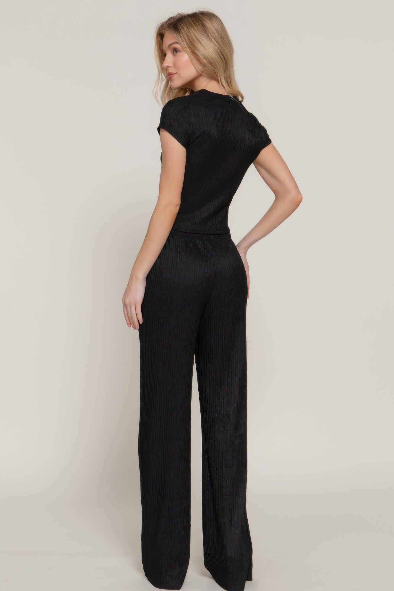 Woman modeling black vacation casual two piece set with short sleeves and wide leg pants from VacationGrabs
