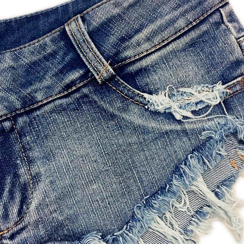 Close-up of vintage blue denim shorts with a frayed hem and distressed detailing