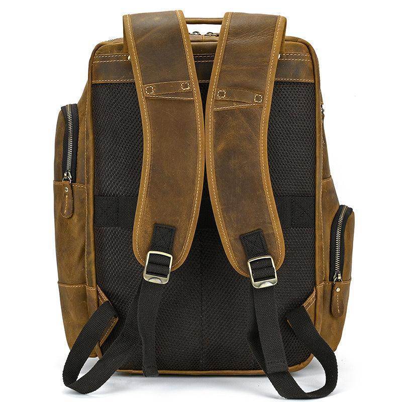 Vintage leather backpack with ergonomic padded straps and multiple storage pockets for travel essentials