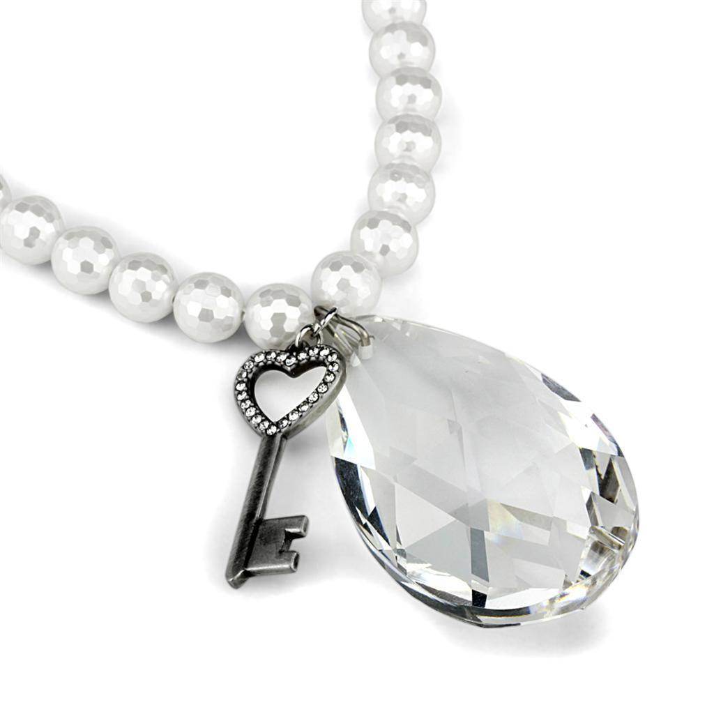White metal vintage style pendant necklace featuring a key charm and a crystal drop design