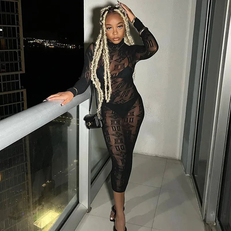 Woman wearing white sheer long sleeve club dress standing on balcony at night