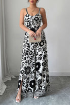 Stylish black and white floral wide leg vacation jumpsuit with side slits and adjustable straps