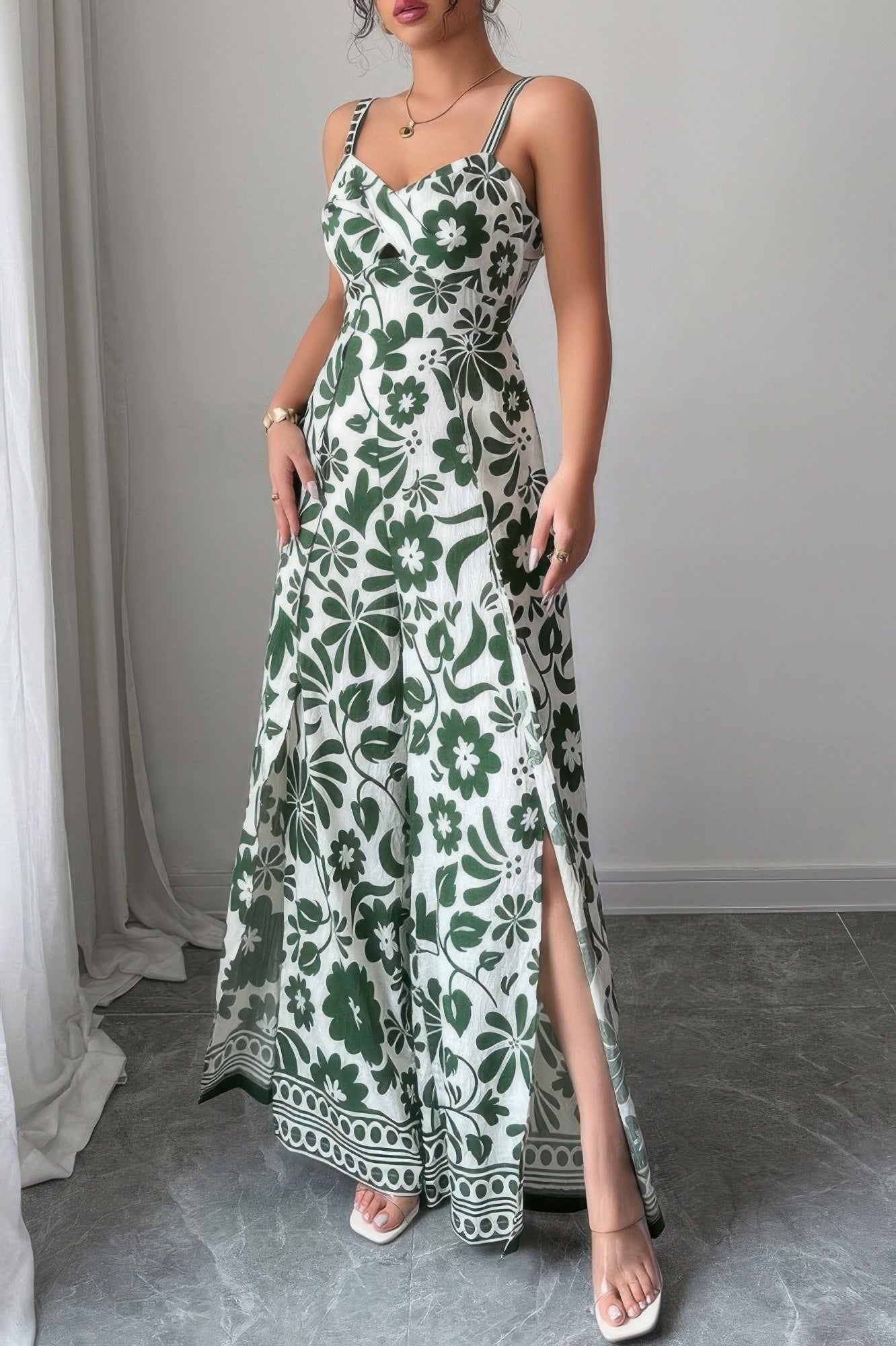 Women's wide leg vacation jumpsuit in green floral print with stylish slit and adjustable straps
