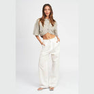 Emory Park wide sleeve crop top in light grey with a button-up design, paired with white pants