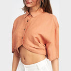 Emory Park wide sleeve crop top in soft peach color with button details and relaxed fit for stylish comfort