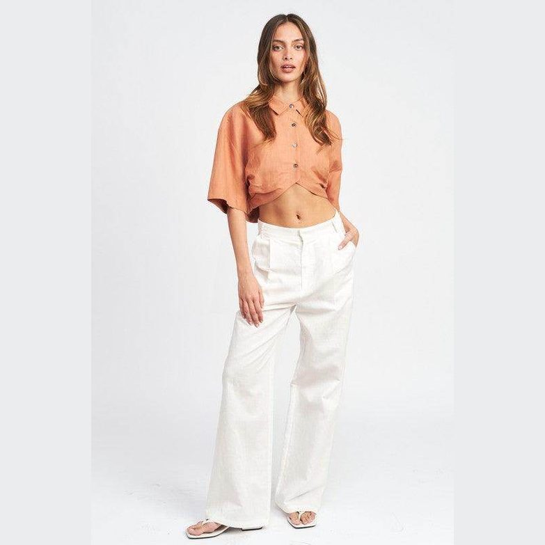 Emory Park wide sleeve crop top in orange with button detail and relaxed fit, paired with white trousers