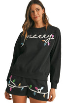 Womens cozy Christmas matching set black sweatshirt and shorts with festive light bulb design