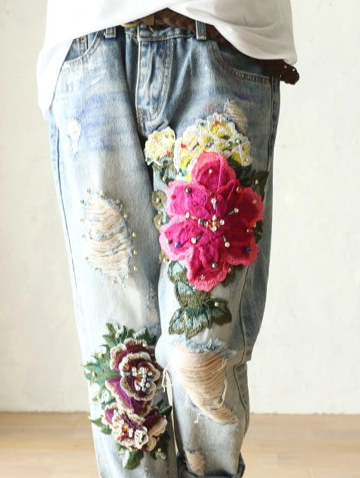 Womens floral embroidery jeans with colorful flower patches and distressed detailing