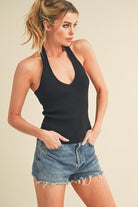 Aemi + Co women's henley tank top in black, styled with denim shorts for a trendy look
