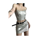 Womens metallic skirt and crop top set in silver with a black belt worn by model