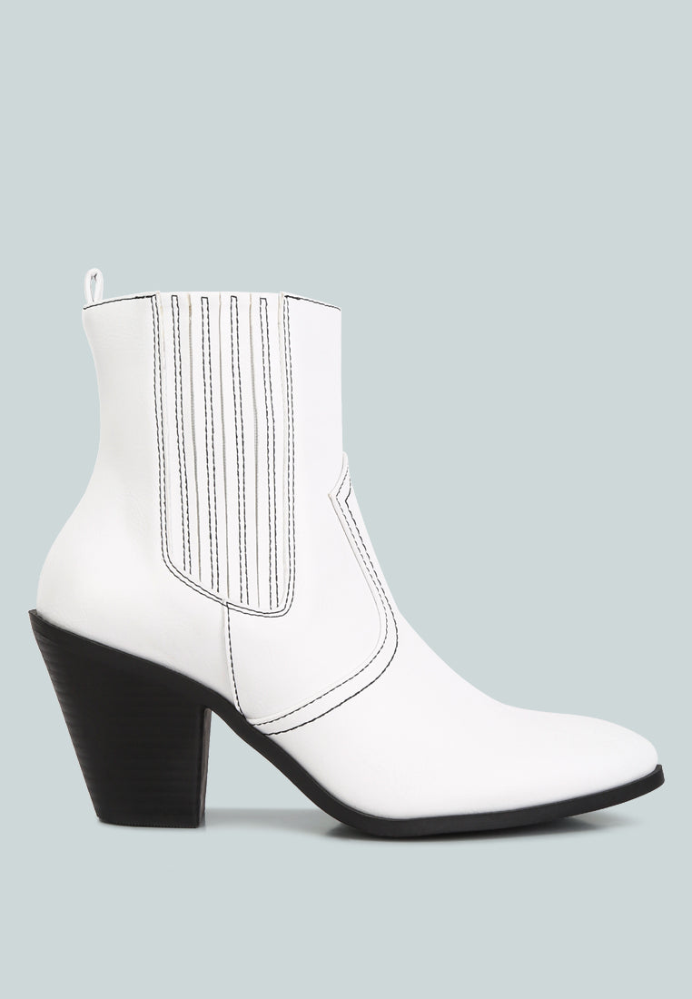 White ankle boot with a black heel on a light gray background