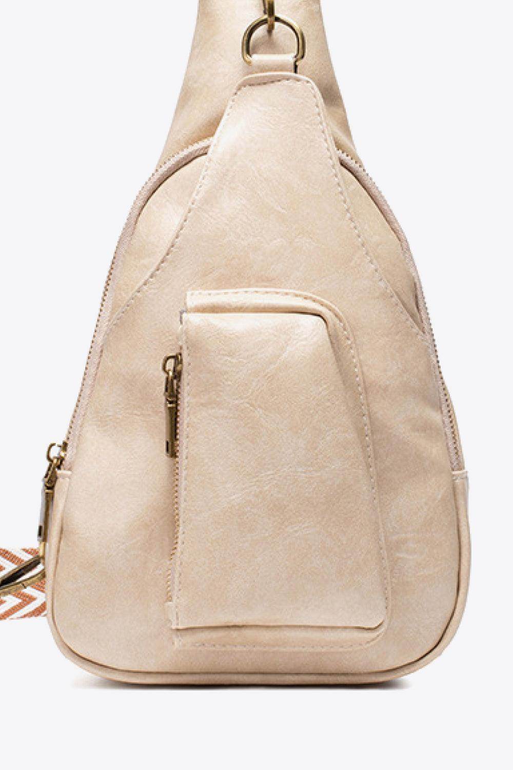 Pink PU leather sling bag with a stylish design and functional front pocket for everyday use