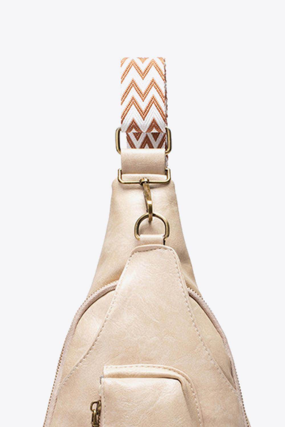 Stylish pink PU leather sling bag with patterned strap and zipper pocket for added convenience
