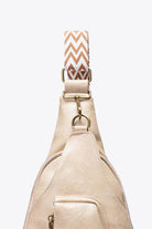 Stylish pink PU leather sling bag with patterned strap and zipper pocket for added convenience
