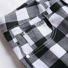 Close-up of VacationGrabs black and white printed jeans with a plaid pattern and stylish details