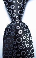 Stylish black orange dot tie featuring a unique circle pattern for men's accessories