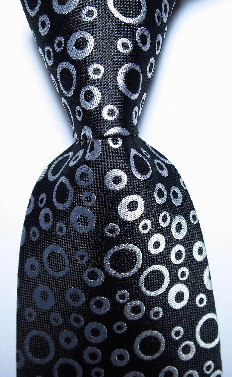 Stylish black orange dot tie featuring a unique circle pattern for men's accessories