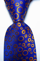 VacationGrabs black orange dot tie featuring a vibrant blue background with circular pattern