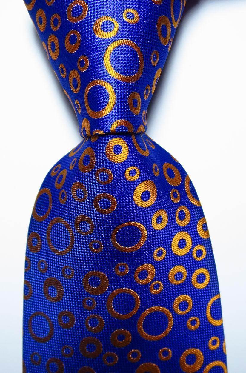 VacationGrabs black orange dot tie featuring a vibrant blue background with circular pattern
