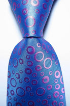 Blue tie featuring vibrant dots, perfect for adding a playful touch to formal attire