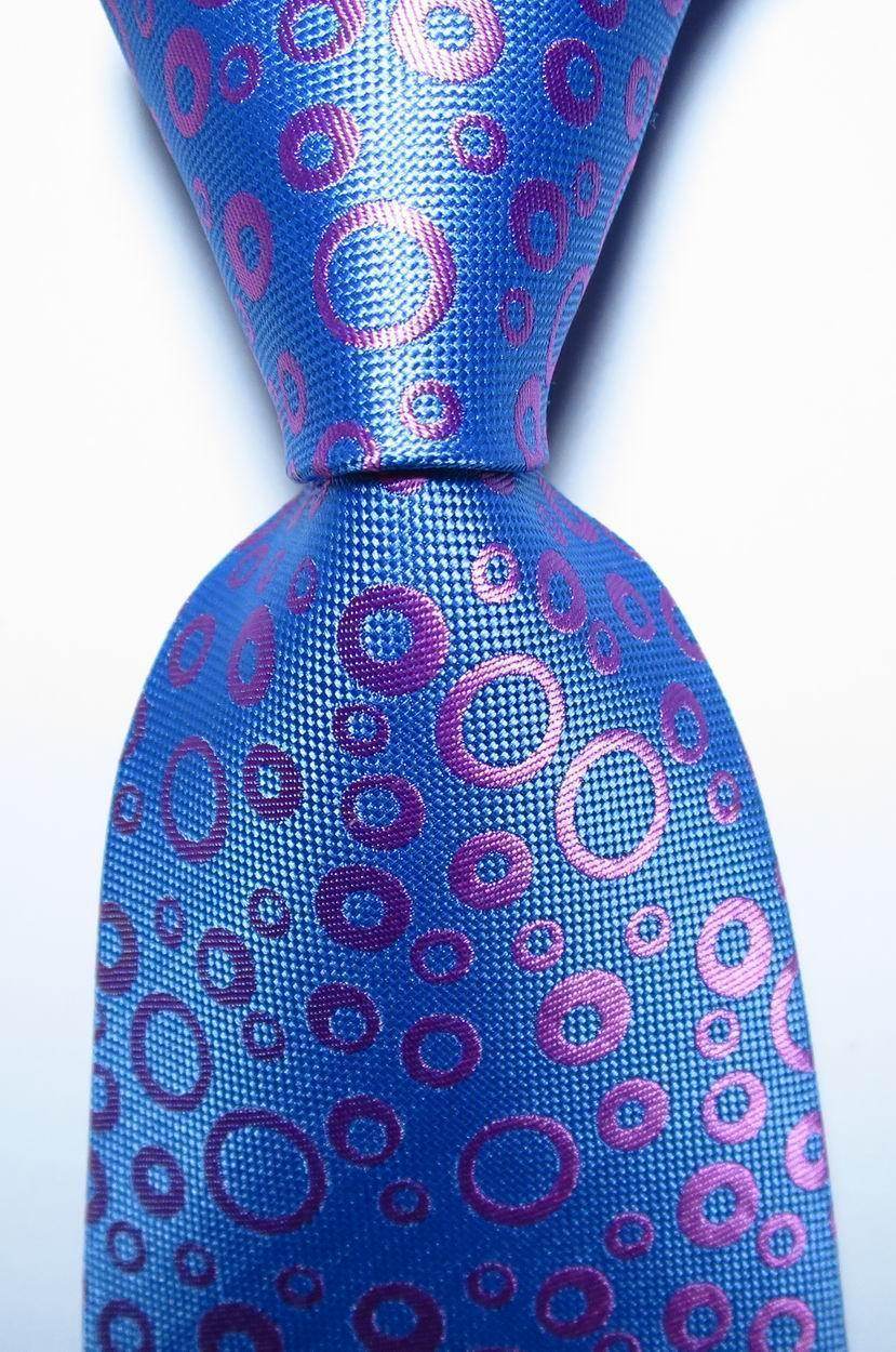Blue tie featuring vibrant dots, perfect for adding a playful touch to formal attire