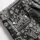 Close-up of black printed jeans for men featuring intricate pattern details and stylish design