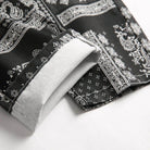Close-up of VacationGrabs black printed jeans for men with intricate paisley design and cuff detail