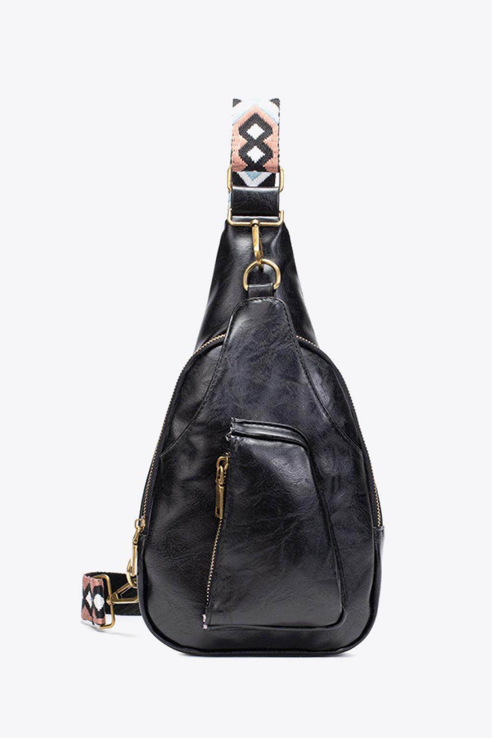 Stylish black sling bag with a unique strap design, perfect for carrying essentials comfortably
