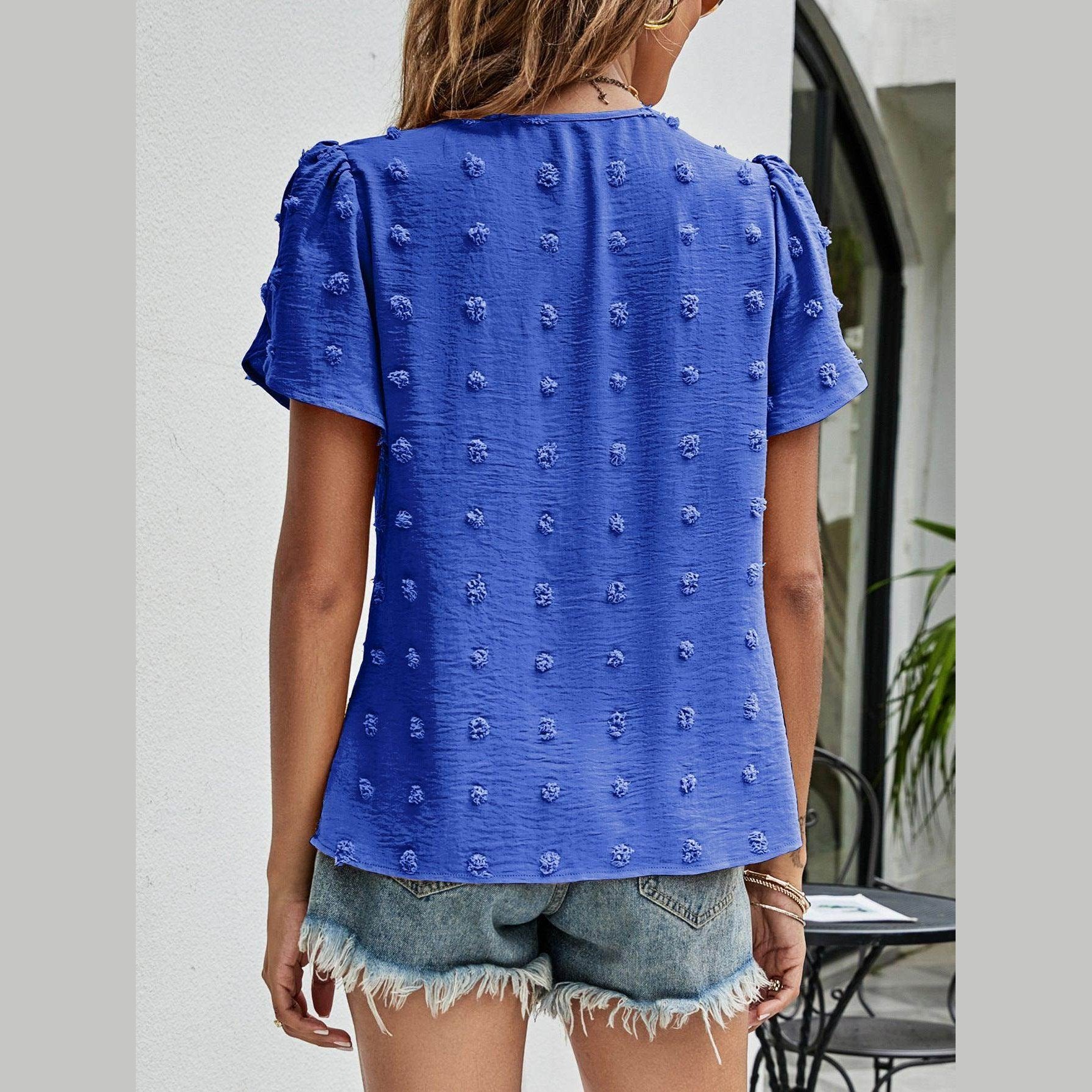 Casual pink Swiss dot top with textured fabric and short sleeves for a relaxed look