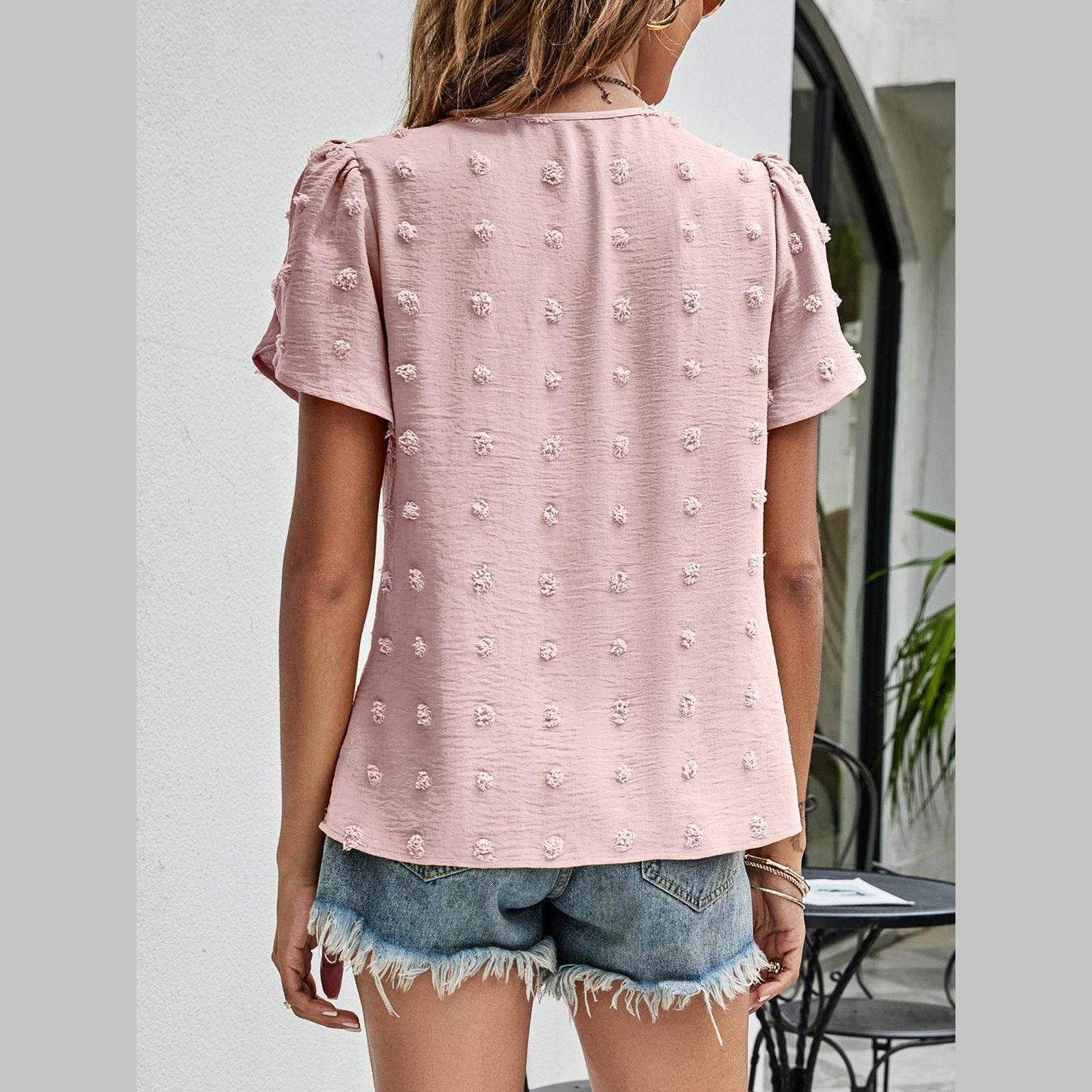 Women's casual pink Swiss dot top with puff sleeves and textured pattern, perfect for summer styling