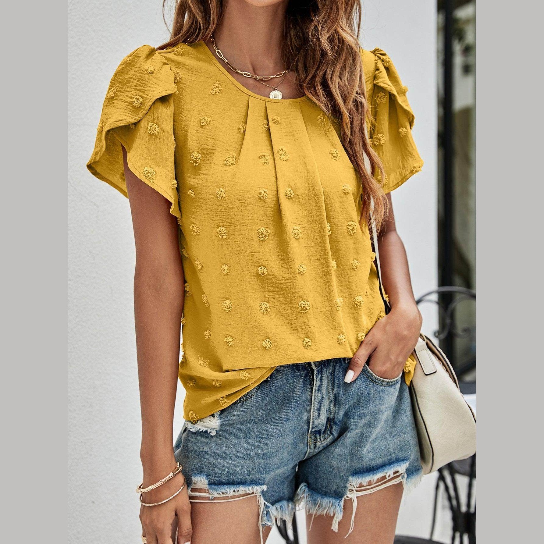 Casual pink Swiss dot top featuring ruffled sleeves and a relaxed fit for a stylish summer look