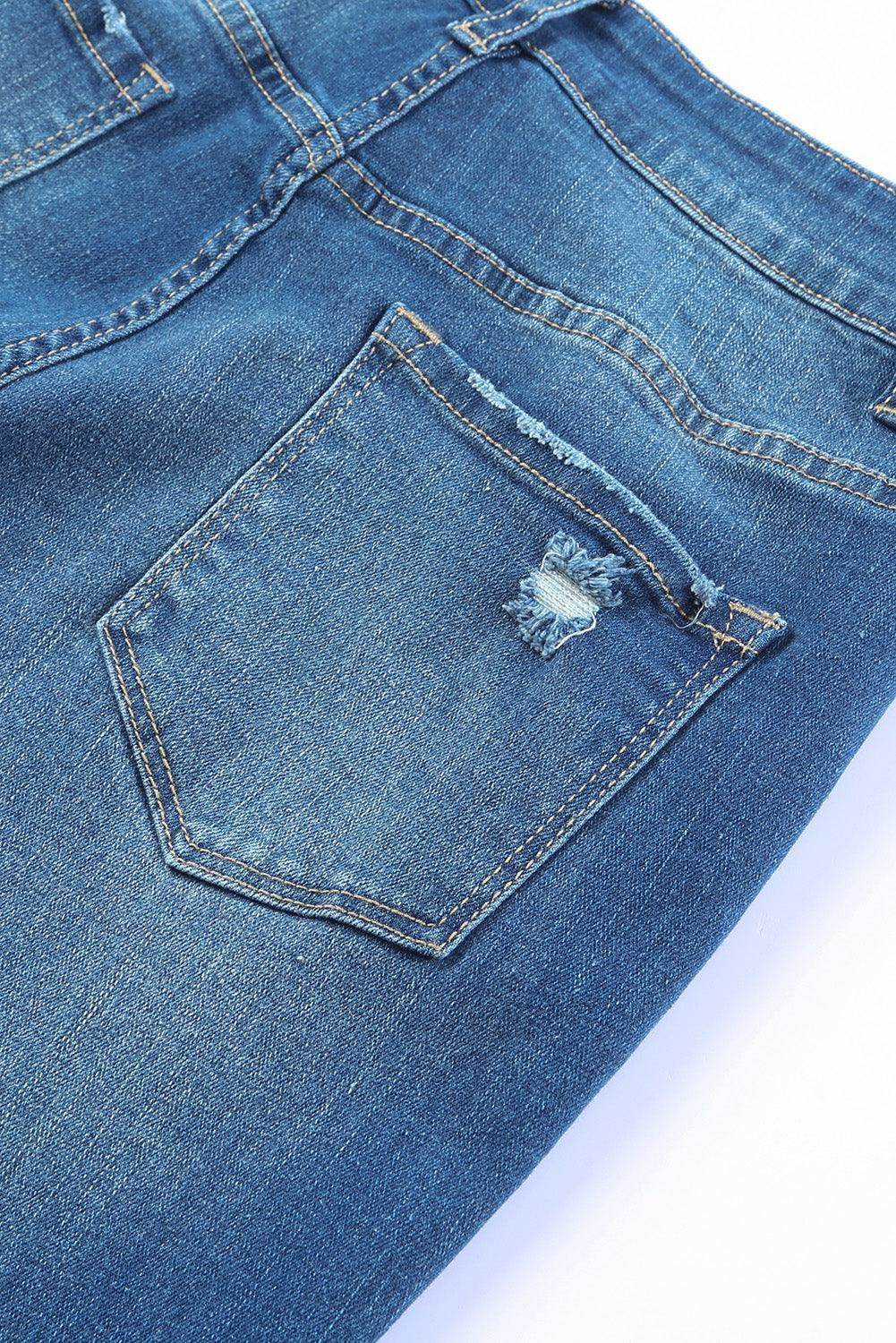 Close-up of VacationGrabs high rise flare jeans showcasing distressed back pocket design