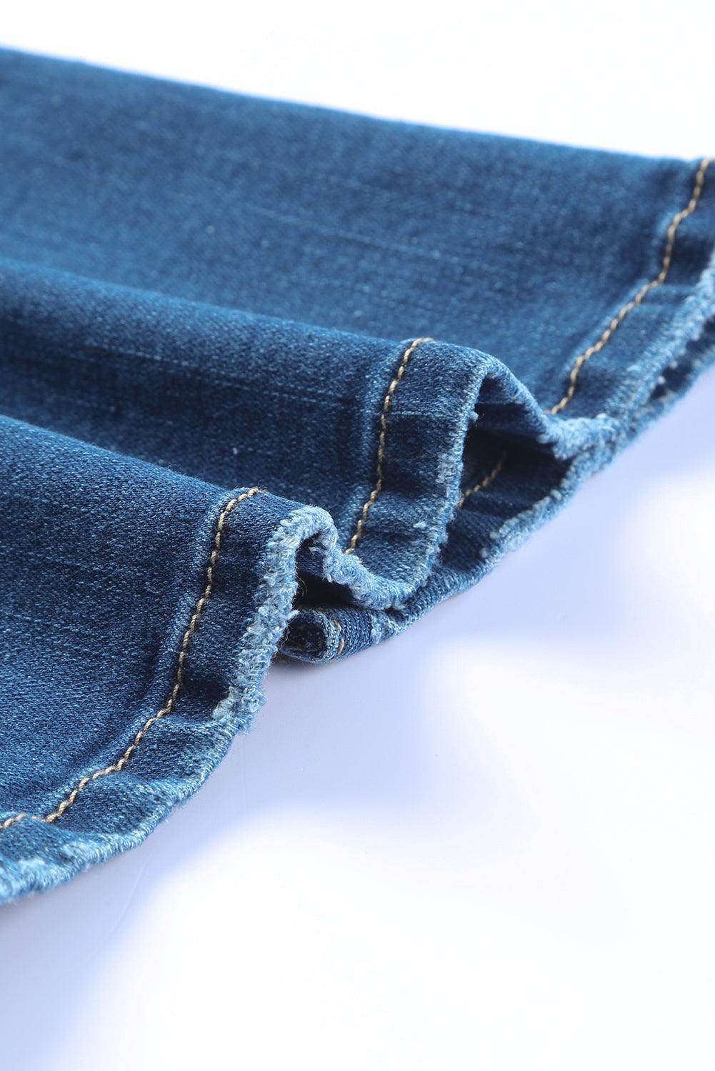 Close-up of the hem detailing on VacationGrabs high rise flare jeans in blue denim fabric