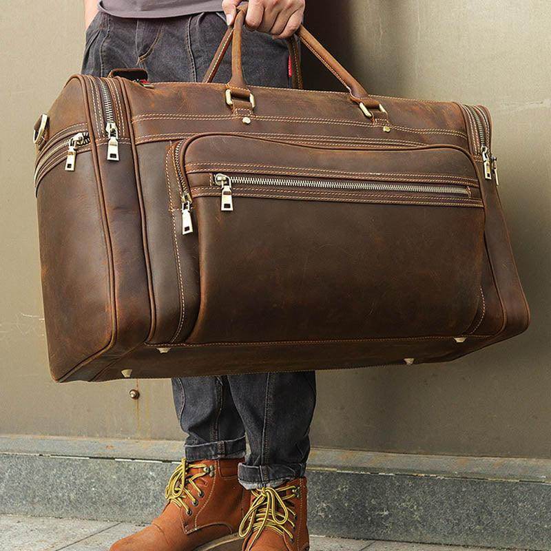 Brown leather luggage tote bag featuring multiple pockets and sturdy handles for travel convenience