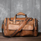 Brown leather travel duffel bag with multiple pockets and an adjustable strap for easy carrying