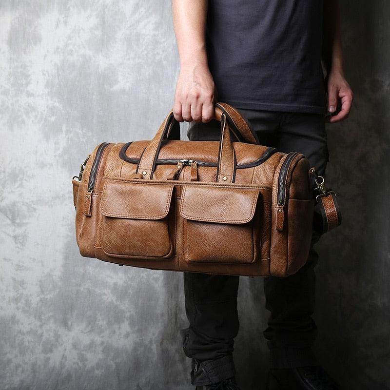 Brown leather travel duffel bag with multiple pockets and sturdy handles for easy carrying