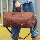 Brown leather weekend bag with shoulder strap for travel and outdoor activities