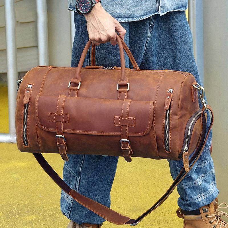 Brown leather weekend bag with shoulder strap for travel and outdoor activities