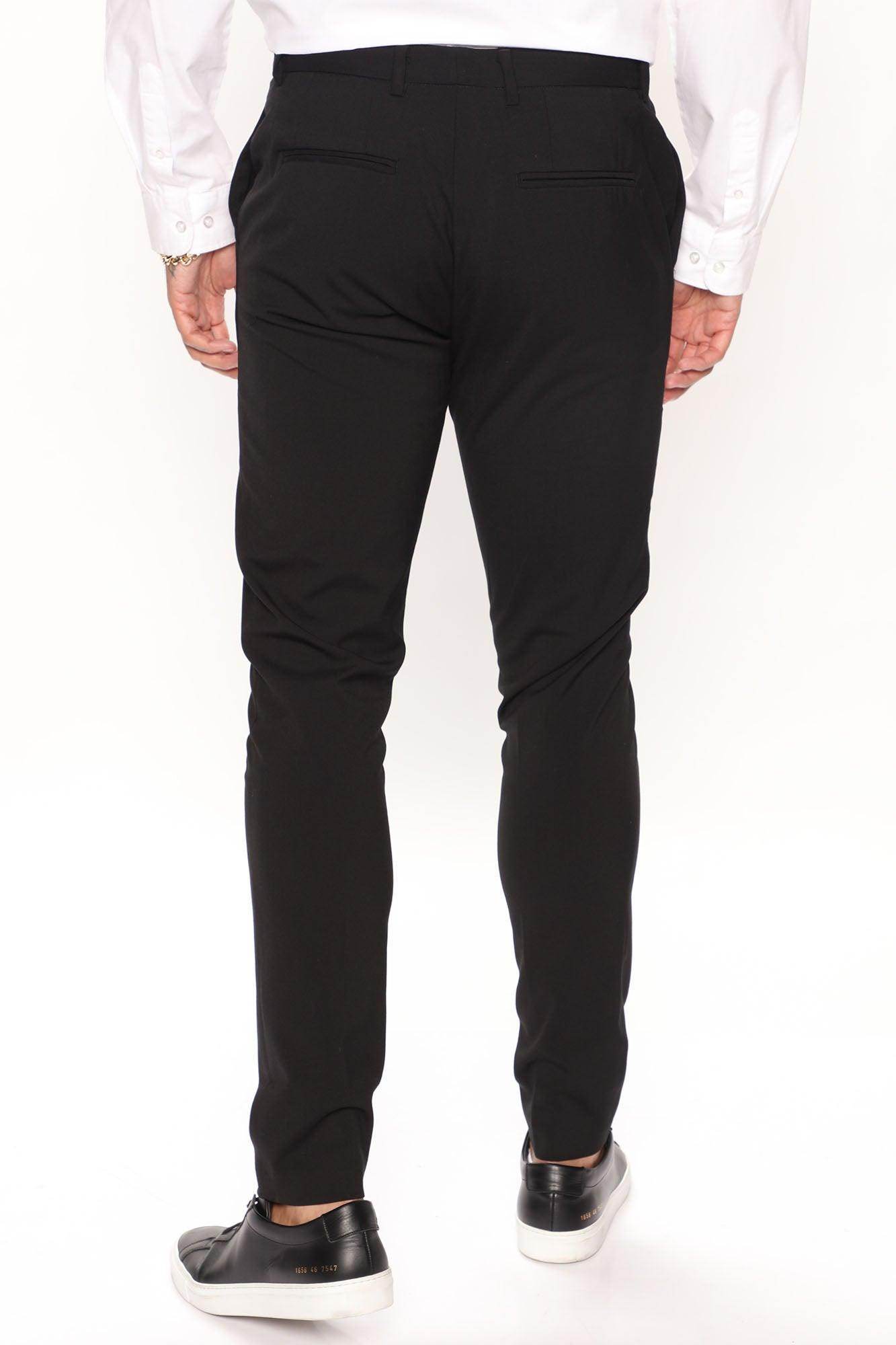Back view of modern slim fit trousers black from Fashion Nova featuring a tailored design for a sleek look