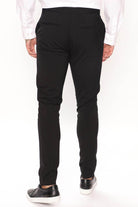 Back view of modern slim fit trousers black from Fashion Nova featuring a tailored design for a sleek look